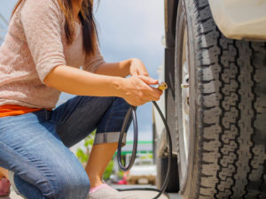 Driver,Checking,Air,Pressure,And,Filling,Air,In,The,Tires