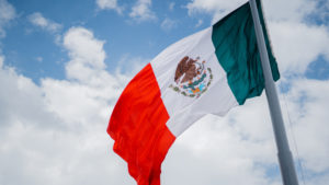 Mexican Flag Waving in the Wind Under a Cloudy Sky