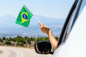 Woman,Holding,Brazil,Flag,From,The,Open,Car,Window,Driving