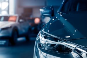 Blurred,Grey,Car,Parked,In,Luxury,Showroom.,Closeup,New,Car