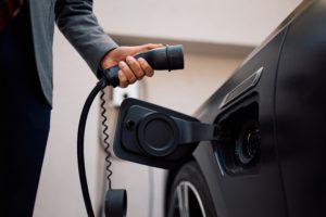 Close,Up,Of,Businessman,Charging,His,Hybrid,Car.